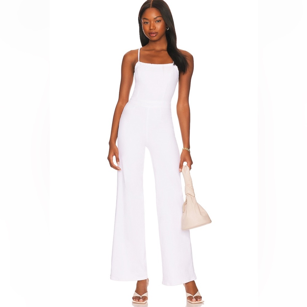 Good American vacay jean jumpsuit. Size 0. Open back with strappy detail! NWT